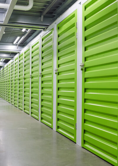 Image of modern warehouse with green storage boxes for storage
